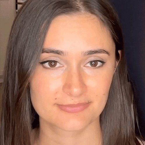 A Close Up Of A Woman 'S Face With Long Hair GIF