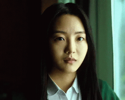 A Close Up Of A Woman 'S Face With Long Hair GIF