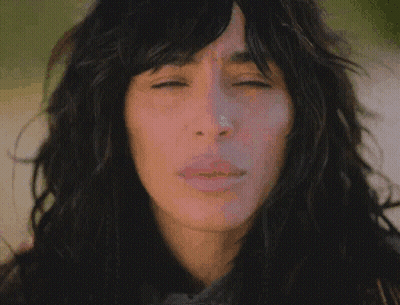 A Close Up Of A Woman 'S Face With Long Hair GIF