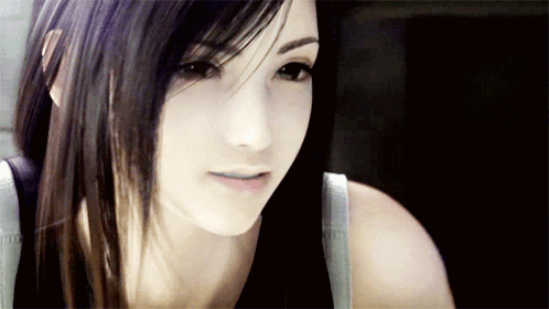 A Close Up Of A Woman 'S Face With Long Hair GIF