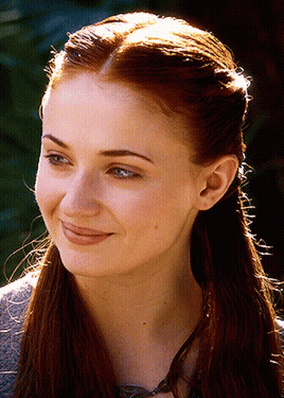 A Close Up Of A Woman 'S Face With Long Red Hair GIF