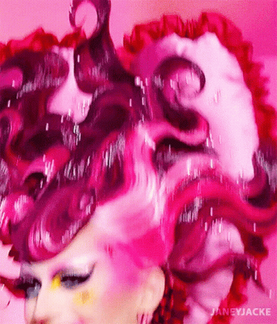 A Close Up Of A Woman 'S Face With Pink Hair GIF