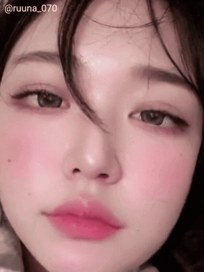 A Close Up Of A Woman 'S Face With Pink Lips GIF