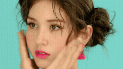 A Close Up Of A Woman 'S Face With Pink Lipstick And Freckles GIF
