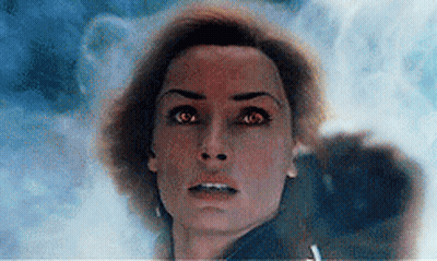 A Close Up Of A Woman 'S Face With Red Eyes Looking At The Camera GIF