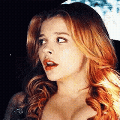 A Close Up Of A Woman 'S Face With Red Hair And A Surprised Look On Her Face GIF