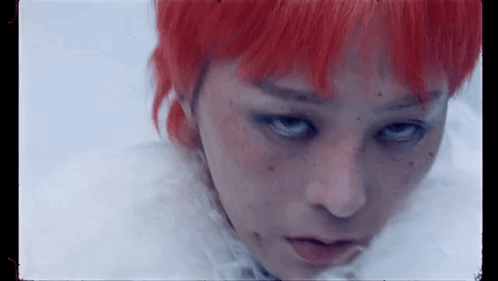 A Close Up Of A Woman 'S Face With Red Hair And Freckles . GIF