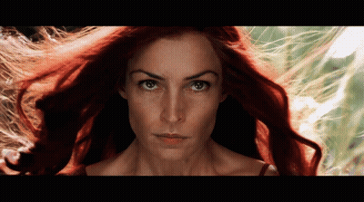 A Close Up Of A Woman 'S Face With Red Hair GIF