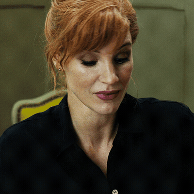 A Close Up Of A Woman 'S Face With Red Hair GIF