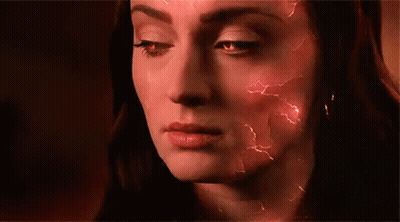 A Close Up Of A Woman 'S Face With Red Lightning Bolts Coming Out Of It . GIF