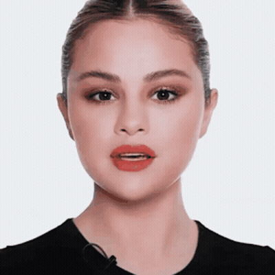 A Close Up Of A Woman 'S Face With Red Lips And A Microphone . GIF