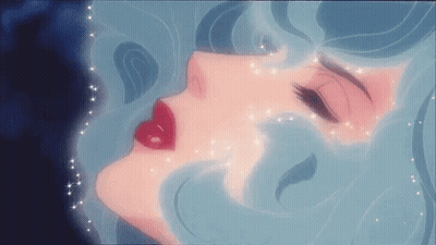 A Close Up Of A Woman 'S Face With Red Lips And Blue Hair . GIF