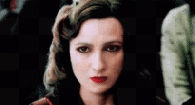 A Close Up Of A Woman 'S Face With Red Lips . GIF