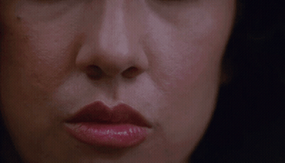 A Close Up Of A Woman 'S Face With Red Lipstick GIF