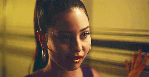 A Close Up Of A Woman 'S Face With Red Lipstick And Hoop Earrings GIF