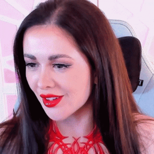 A Close Up Of A Woman 'S Face With Red Lipstick . GIF