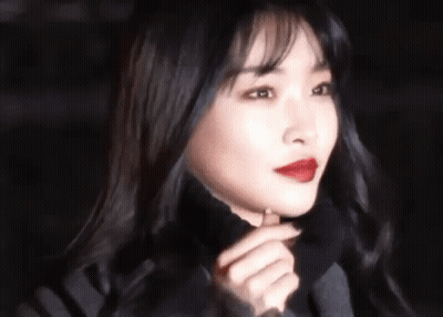 A Close Up Of A Woman 'S Face With Red Lipstick . GIF