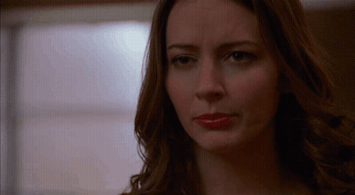 A Close Up Of A Woman 'S Face With Red Lipstick On Her Lips . GIF