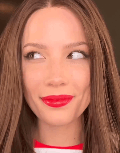 A Close Up Of A Woman 'S Face With Red Lipstick On Her Lips GIF