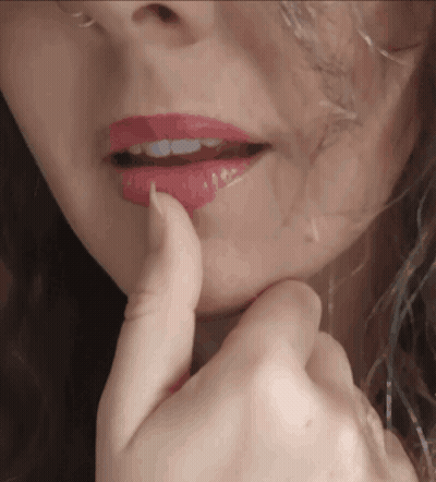 A Close Up Of A Woman 'S Face With Red Lipstick On Her Lips GIF