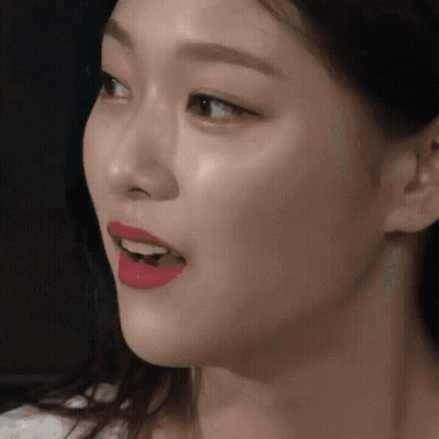 A Close Up Of A Woman 'S Face With Red Lipstick On GIF