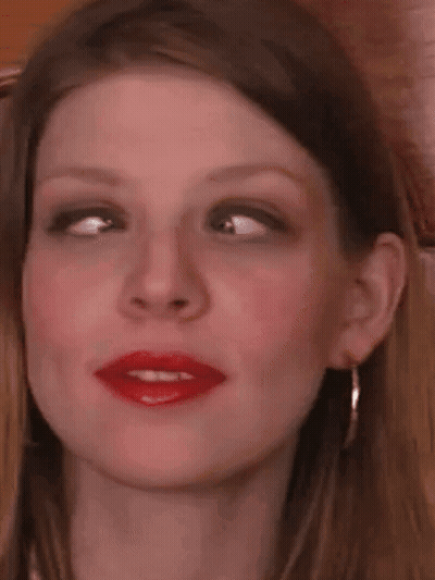 A Close Up Of A Woman 'S Face With Red Lipstick On . GIF
