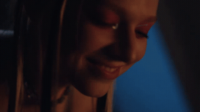 A Close Up Of A Woman 'S Face With Red Makeup GIF