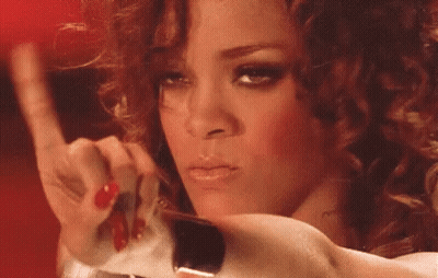 A Close Up Of A Woman 'S Face With Red Nails Holding A Piece Of Paper . GIF