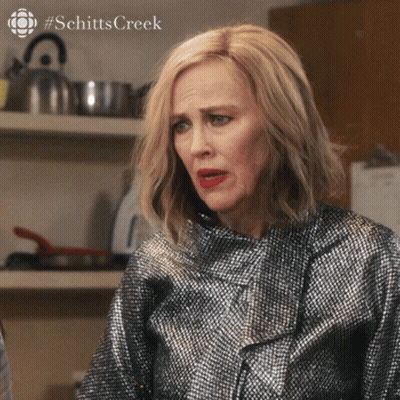 A Close Up Of A Woman 'S Face With #Schitts Creek On The Bottom Right GIF