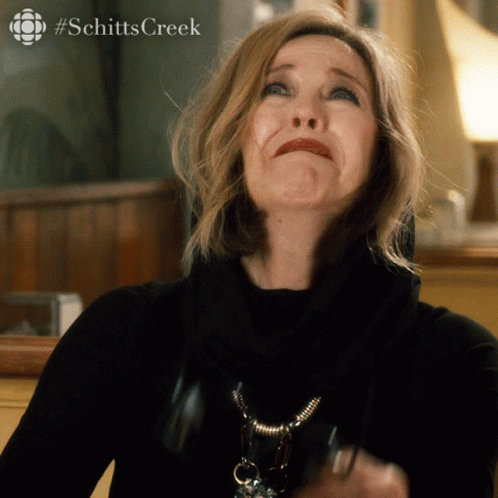 A Close Up Of A Woman 'S Face With #Schittscreek Written On The Bottom GIF