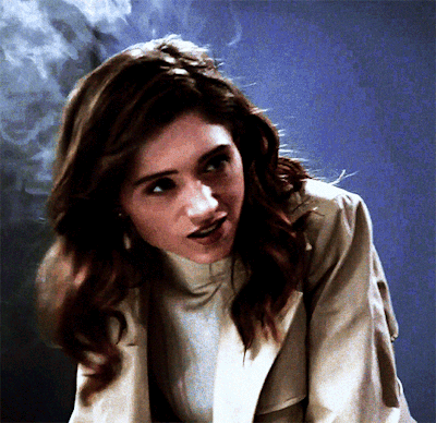 A Close Up Of A Woman 'S Face With Smoke Coming Out Of Her Hair GIF