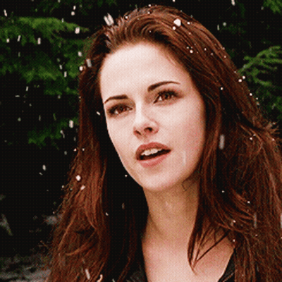 A Close Up Of A Woman 'S Face With Snow Falling GIF