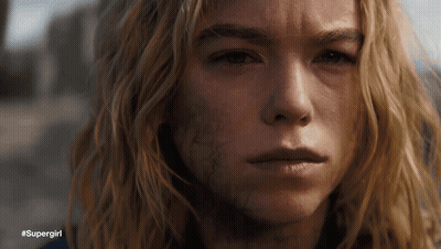 A Close Up Of A Woman 'S Face With #Supergirl Written Below Her GIF