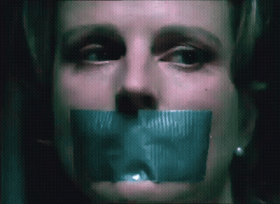 A Close Up Of A Woman 'S Face With Tape On Her Mouth GIF