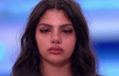 A Close Up Of A Woman 'S Face With Tears Coming Out Of Her Eyes GIF