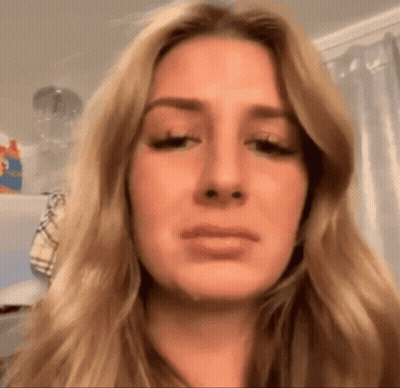 A Close Up Of A Woman 'S Face With Tears Running Down Her Cheeks GIF