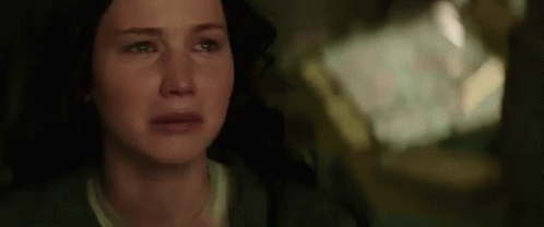 A Close Up Of A Woman 'S Face With Tears Running Down Her Cheeks . GIF