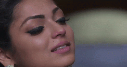 A Close Up Of A Woman 'S Face With Tears Running Down Her Face . GIF