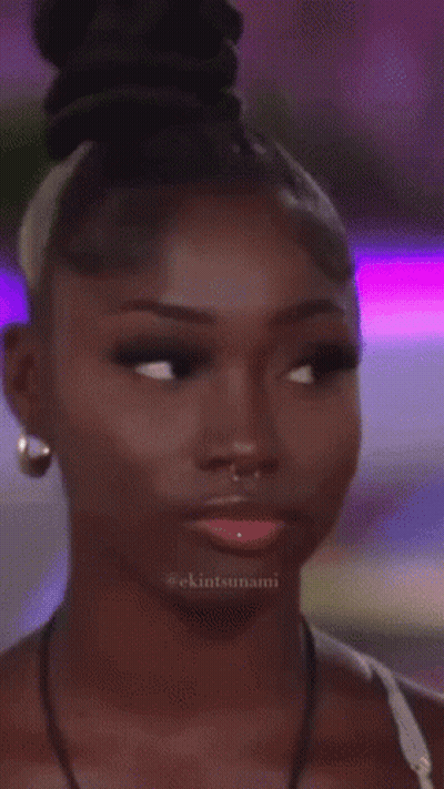 A Close Up Of A Woman 'S Face With The Hashtag Ekintsunami On The Bottom GIF