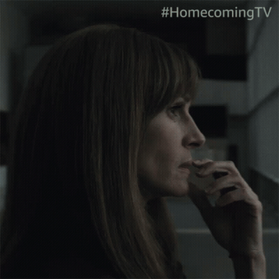 A Close Up Of A Woman 'S Face With The Hashtag #Homecomingtv On The Bottom GIF