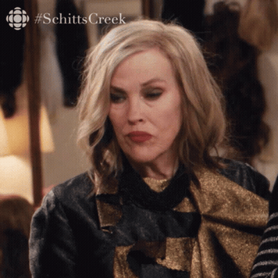 A Close Up Of A Woman 'S Face With The Hashtag Schitts Creek Visible GIF