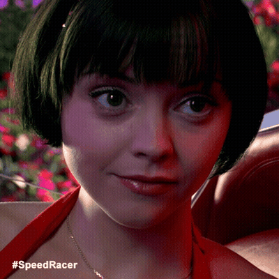 A Close Up Of A Woman 'S Face With The Hashtag #Speedracer Below Her GIF