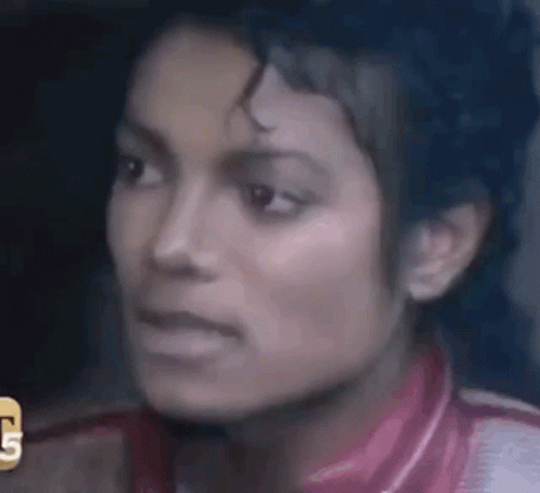 A Close Up Of A Woman 'S Face With The Letter G On The Bottom Right GIF
