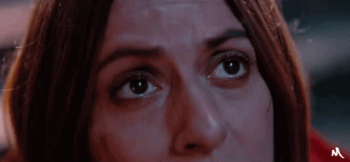 A Close Up Of A Woman 'S Face With The Letter M On The Bottom GIF