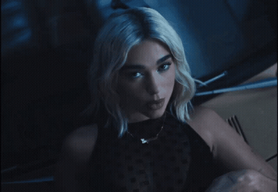 A Close Up Of A Woman 'S Face With The Letter S In Her Mouth GIF