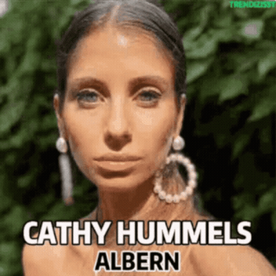 A Close Up Of A Woman 'S Face With The Name Cathy Hummels Albern Above Her GIF