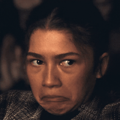 A Close Up Of A Woman 'S Face With The Name David Worren Written On Her Shirt GIF
