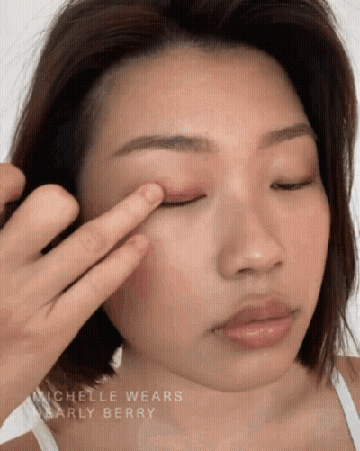 A Close Up Of A Woman 'S Face With The Name Michelle Wears Nearly Berry On The Bottom GIF