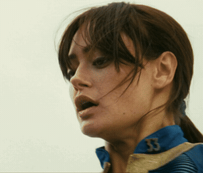 A Close Up Of A Woman 'S Face With The Number 53 On Her Jacket GIF