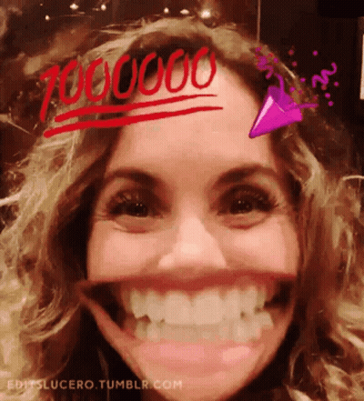 A Close Up Of A Woman 'S Face With The Number 700000 Written On Her Forehead .. GIF